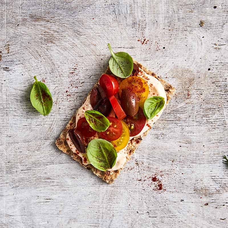 Crispbread topped with capsicum dip and bocconcini