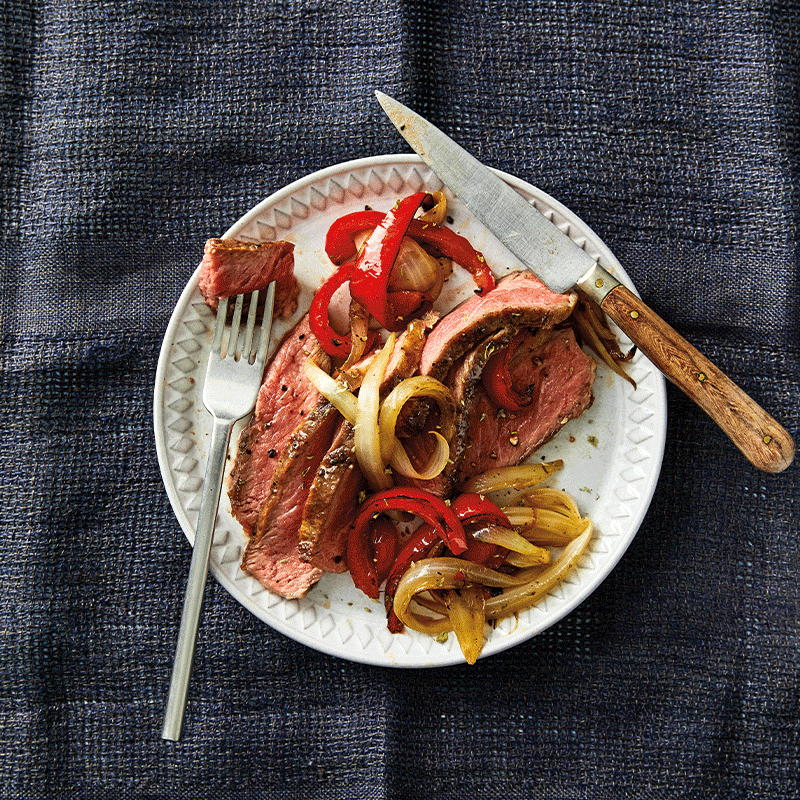 Grilled steak with roasted capsicum and onions
